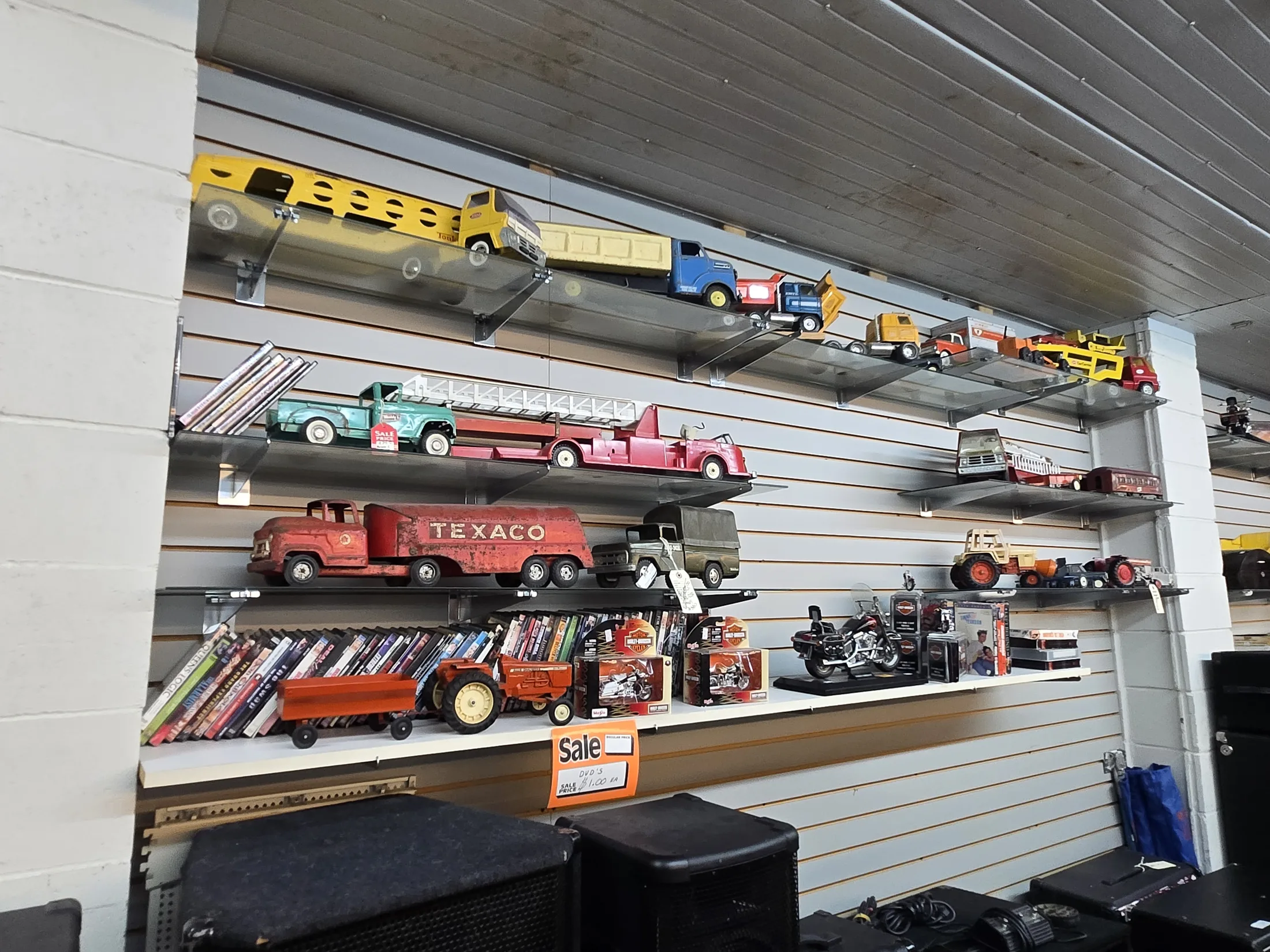 Collectible toy trucks and tractors on shelves at AAA Gun & Pawn